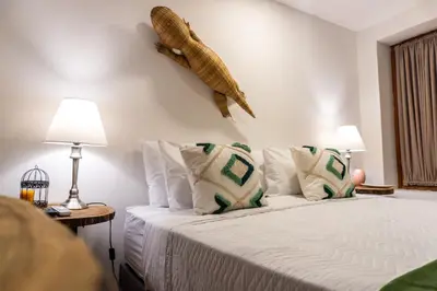 a bedroom with a bed with a fish on the wall at Candilejo Hotel Boutique in Cartagena de Indias