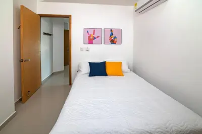 a small bedroom with a large bed in it at Magico Apartamento Frente al Mar 2 Habitaciones B11A in Coveñas