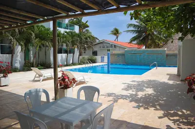 a patio with a table and chairs and a pool at Magico Apartamento Frente al Mar 2 Habitaciones B11A in Coveñas