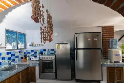 a kitchen with a stainless steel refrigerator and a stove at Cabana Canaima in Coveñas