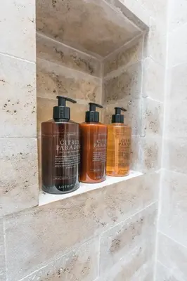 three bottles of soap sitting on a shelf in a bathroom at Casa Jaguar Hotel Boutique in Cartagena de Indias