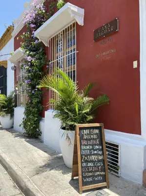 a sign in front of a building with plants at Casa Jaguar Hotel Boutique in Cartagena de Indias
