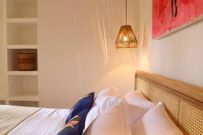 a bedroom with a bed with pillows and a lamp at Casa Jaguar Hotel Boutique in Cartagena de Indias