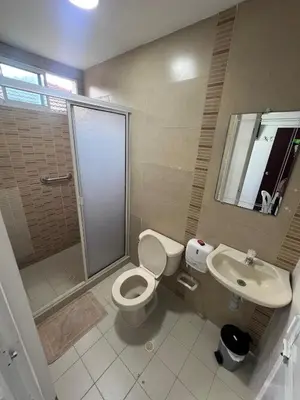 a bathroom with a shower and a toilet and a sink at Garden Home Hostal in Barranquilla