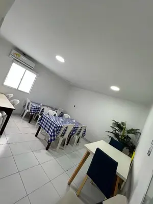a dining room with a table and chairs at Garden Home Hostal in Barranquilla