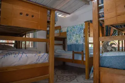 a room with three bunk beds in a house at L' Europe in Isla Fuerte