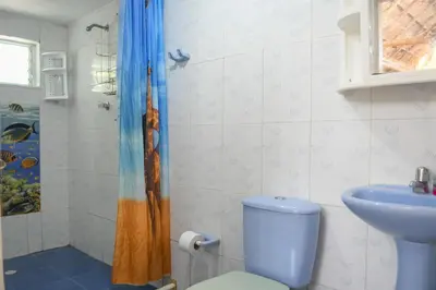 a bathroom with a toilet and a sink and a shower at L' Europe in Isla Fuerte
