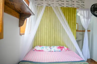 a bed with two pillows on it in a bedroom at L' Europe in Isla Fuerte