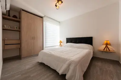 a bedroom with a large white bed and two lamps at Nuevo apartamento en la zona norte de Cartagena in Puerto Tierrabaja