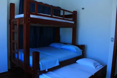 two bunk beds in a room with a blue light at Cabaña Villas de Santa Veronica in Juan de Acosta