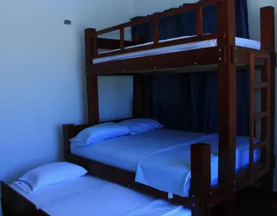two bunk beds in a room with blue lights at Cabaña Villas de Santa Veronica in Juan de Acosta