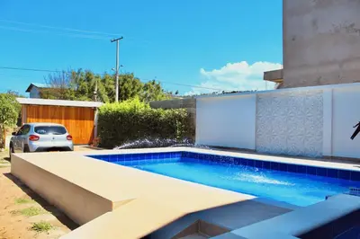 a swimming pool in the backyard of a house at Cabaña Villas de Santa Veronica in Juan de Acosta