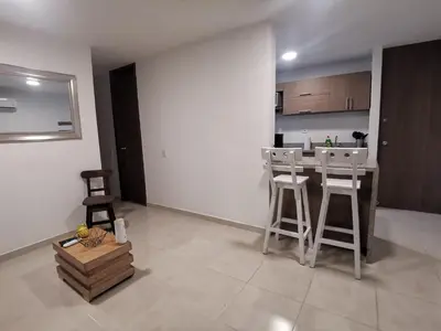 a kitchen with a counter and stools in a room at Hermoso Apartamento Zona Norte Miramar # in Barranquilla