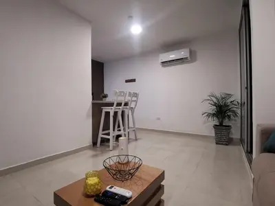 a living room with a couch and a table at Hermoso Apartamento Zona Norte Miramar # in Barranquilla