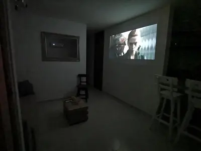 a dark room with a tv with a movie on it at Hermoso Apartamento Zona Norte Miramar # in Barranquilla