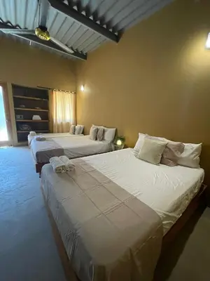 a room with two beds in a room at Casa Bustani Isla in Bocachica