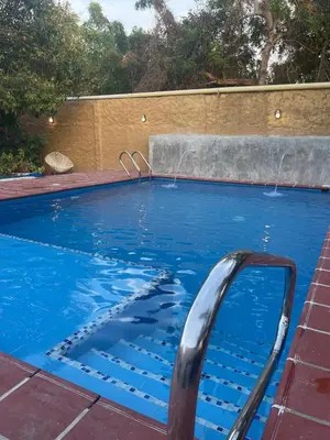 a swimming pool with blue water in a yard at Casa Bustani Isla in Bocachica