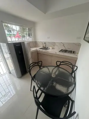 a table and chairs in a kitchen with a sink at Apartamento in Cartagena de Indias