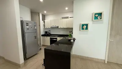 a kitchen with a stainless steel refrigerator and a stove at Hermoso Apartamento frente al mar, 4 habitaciones - Apto 801 in Coveñas