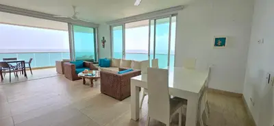 a living room with a view of the ocean at Hermoso Apartamento frente al mar, 4 habitaciones - Apto 801 in Coveñas