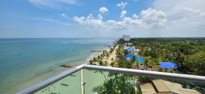 a view of the beach from the balcony of a resort at Hermoso Apartamento frente al mar, 4 habitaciones - Apto 801 in Coveñas