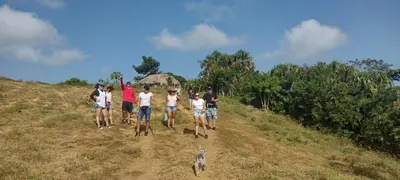 a group of people walking down a hill with a dog at El Viejo del Mar in San Bernardo del Viento