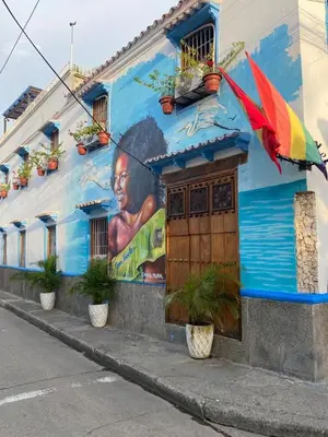 a building with a painting of a woman with an umbrella at Casa Gran Fuente in Cartagena de Indias