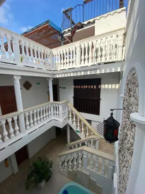 an external view of a white house with a staircase at Casa Gran Fuente in Cartagena de Indias