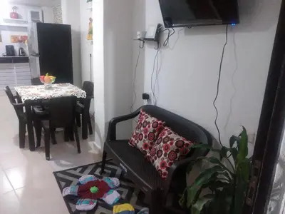a living room with a chair and a table at Encantadora casa con ambiente guajiro 2 in Barranquilla