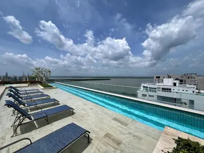 a swimming pool with lounge chairs on the roof of a building at 1 Dormitorio Cielo Mar. Jacuzzi Privado in Cartagena de Indias