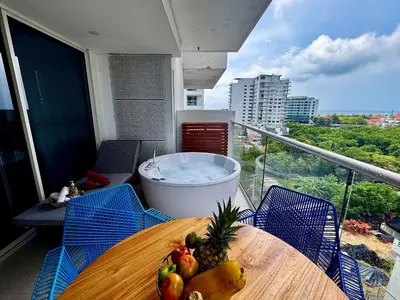 a table with fruit on a balcony with a hot tub at 1 Dormitorio Cielo Mar. Jacuzzi Privado in Cartagena de Indias