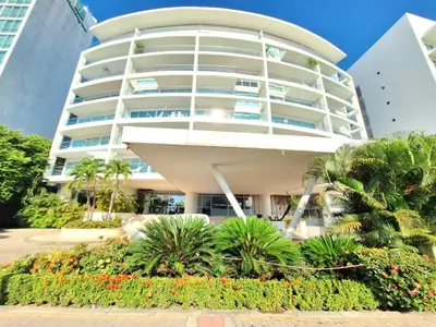 a large white building with plants in front of it at Apto vacacional Morros 3 - Salida directa al mar in Cartagena de Indias