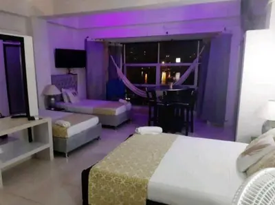 a bedroom with a purple room with a bed and a table at Loft facing the sea MR1-2G upper class neighborhood in Cartagena de Indias