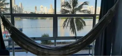 a hammock in front of a window with a palm tree at Loft facing the sea MR1-2G upper class neighborhood in Cartagena de Indias