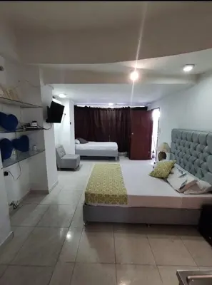 a large bedroom with two beds and a couch at Loft in front of the sea MR1-1G neighbourhood strato alto in Cartagena de Indias