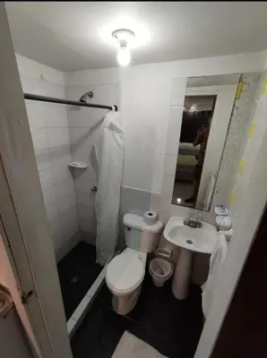 a small bathroom with a toilet and a sink at Loft in front of the sea MR1-1G neighbourhood strato alto in Cartagena de Indias
