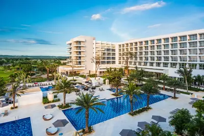 an aerial view of a hotel with a pool and palm trees at Dreams Karibana Cartagena Golf & Spa Resort in Cartagena de Indias