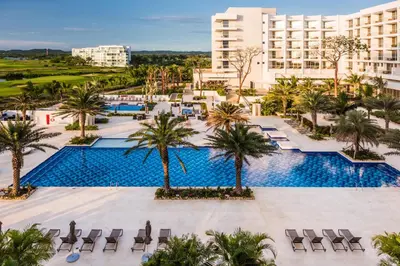 an aerial view of a resort pool with palm trees at Dreams Karibana Cartagena Golf & Spa Resort in Cartagena de Indias