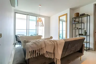 a living room with a couch and some windows at Laurdhomes Palmetto Beach Sew View, Hot Water in Cartagena de Indias