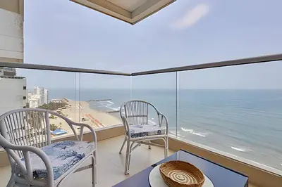 two chairs and a table on a balcony with the ocean at Laurdhomes Palmetto Beach Sew View, Hot Water in Cartagena de Indias