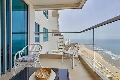 a balcony with chairs and a view of the beach at Laurdhomes Palmetto Beach Sew View, Hot Water in Cartagena de Indias