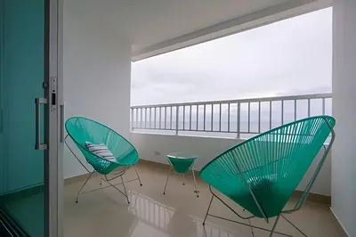 two green chairs in a room with a balcony at LaurdHomes Palmetto Sea View, 2Rooms 2BTH Hot Ware in Cartagena de Indias