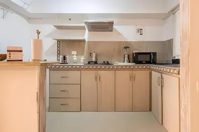 a kitchen with white cabinets and a counter top at Laurdhomes Duplex Old City, Plaza Santo Domingo in Cartagena de Indias
