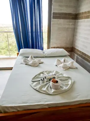 two beds with towels and a tray of food on them at Arenillas del Mar in Tolú