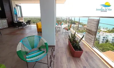 a room with a chair and a view of the ocean at Arenillas del Mar in Tolú