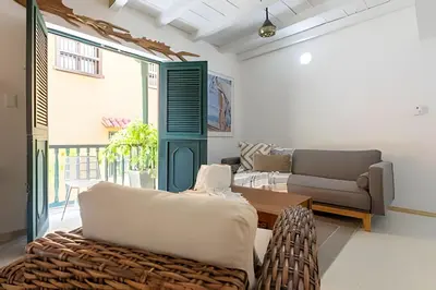 a living room with a couch and a table at Laurdhomes Historic Center Plaza SantoDomingo 3Bth in Cartagena de Indias