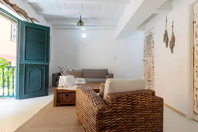 a living room with a wicker chair and a table at Laurdhomes Historic Center Plaza SantoDomingo 3Bth in Cartagena de Indias