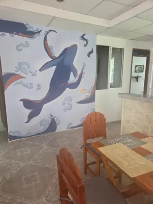 a dining room with a dolphin mural on the wall at Casa de descanso Cartagena-Turbaco in Turbaco