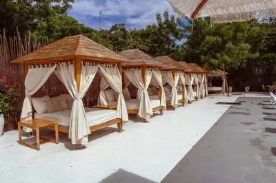 a row of beds in a row on a patio at Bora Bora Beach Club Cartagena in Isla Grande