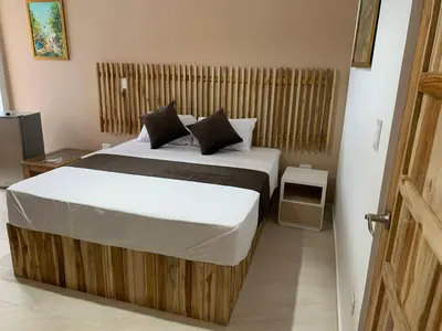 a bedroom with a large bed in a room at Hotel Bahia Rada in Moñitos